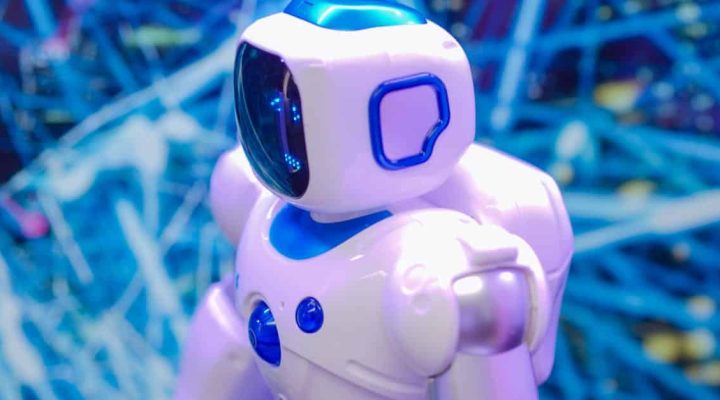 Close-up of a white and blue robot against a dynamic, futuristic tech backdrop.